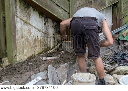 Workers At The Laying And Clipping Of Natural Stone Plates