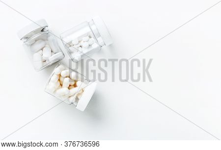Three Packages With Various White Pills And Capcules On A White Background. Health Concept. Copy Spa