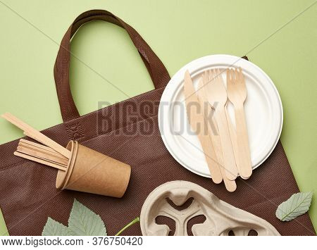 Disposable Paper Utensils From Brown Craft Paper And Recycled Materials On A Green Background, Plast