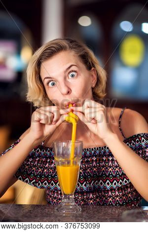 A Worker Measuring Temperature Of Woman Visitior Inside  Of The Cafe. Life During Coronavirus Time