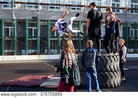 Norilsk, Russia - August, 28, 2016: Young Teenager Jumps And Does Somersaults. Parkour On The Street