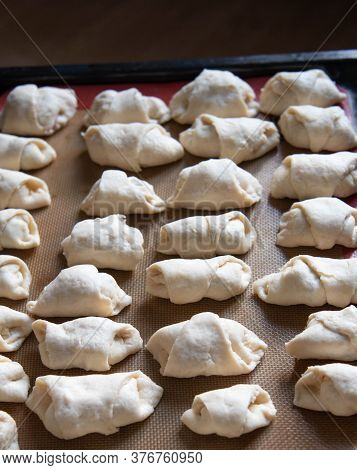 Small Homemade Croissants In The Form Before Baking.