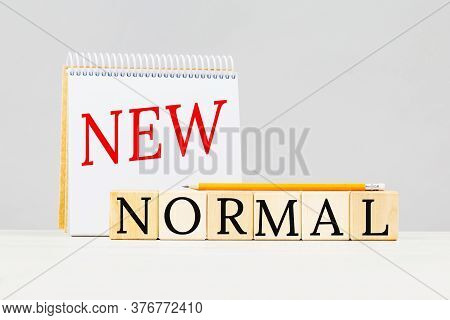 New Normal Text On Building Blocks And A Notepad. Red And Black. Adapting To New Life Or Business Po