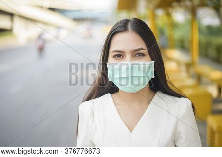 Beautiful Woman Is Wearing Face Mask In Bus Stop