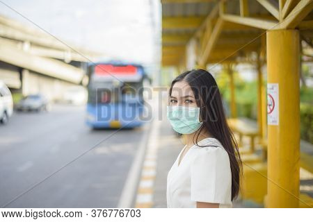 Beautiful Woman Is Wearing Face Mask In Bus Stop