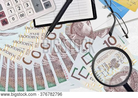 10 Polish Zloty Bills And Calculator With Glasses And Pen. Tax Payment Season Concept Or Investment 