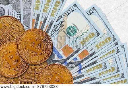 100 Us Dollars Bills And Golden Bitcoins. Cryptocurrency Investment Concept. Crypto Mining Or Tradin