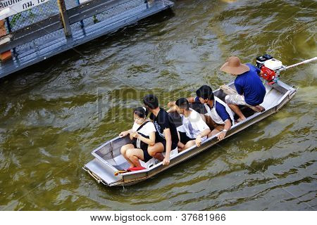 Unidentified people have to travel by boat on the road during flood