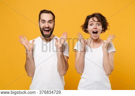 Surprised Young Couple Friends Bearded Guy Girl In White Blank Empty T-shirts Isolated On Yellow Ora