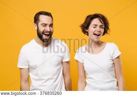 Funny Young Couple Friends Bearded Guy Girl In White Empty Blank T-shirts Posing Isolated On Yellow 
