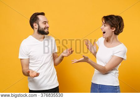 Funny Young Couple Friends Bearded Guy Girl In White T-shirts Posing Isolated On Yellow Orange Backg
