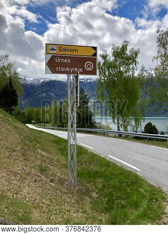 Urnes, Norway/may 13, 2019. Road Sign Directs Travelers To The Town Of Solvorn Or To The Urnes Stave