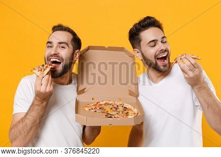 Close Up Of Funny Young Men Guys Friends In White Blank T-shirts Posing Isolated On Yellow Orange Ba