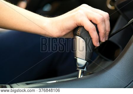 Close Up Of Woman Driver Holding Her Hand On Automatic Gear Shift Stick Driving As Car.