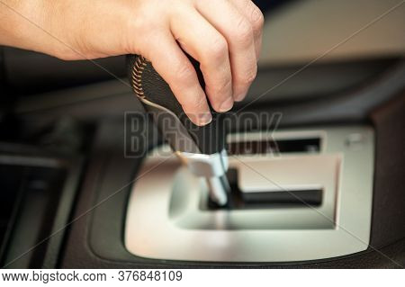 Close Up Of Woman Driver Holding Her Hand On Automatic Gear Shift Stick Driving As Car.