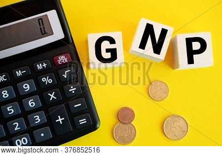 Gnp Gross Domestic Product Word Made With Wooden Blocks On Yellow Background.