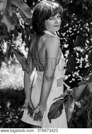 Miniature Mature Woman Resting On Nature And Enjoying Weekend. The Concept Of Harmony With Life And 