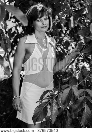 Miniature Mature Woman Resting On Nature And Enjoying Weekend. The Concept Of Harmony With Life And 