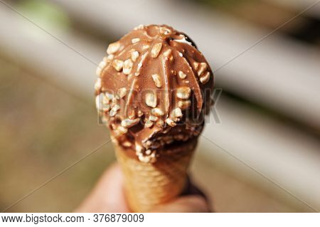 Holds In A Cone Ice Cream With Chocolate