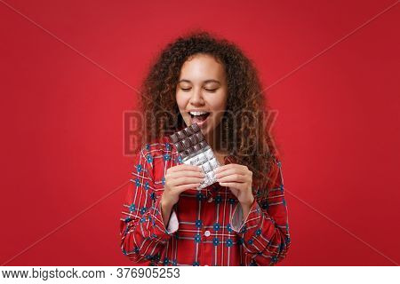 Pretty Young African American Girl In Pajamas Homewear Rest At Home Isolated On Red Background. Rela