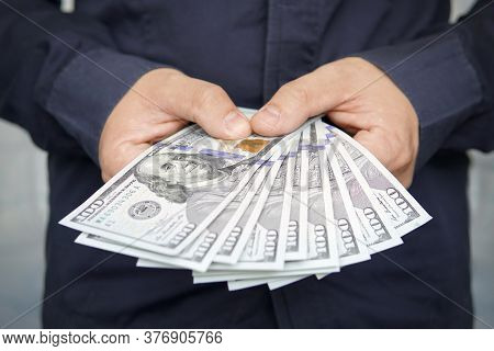 Male Hands With Wrist Watch Is Considered American Dollars. Hands Holding Dollar Cash. 1000 Dollars 