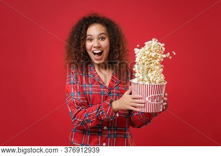 Excited Young African American Girl In Pajamas Homewear Posing While Resting At Home Isolated On Red