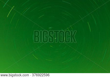 Background Of Round Or Circular Star Track Or Trajectory On The Green Clear Night Sky. Symbol Of Spa