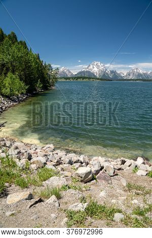 Shores Of Jackson Lake, Near The Jackson Lake Dam In Grand Teton National Park On A Sunny Summer Day