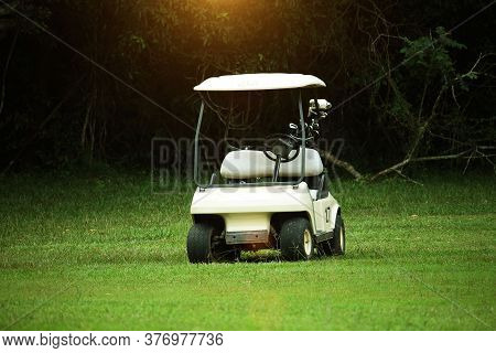Golfcar In Beautiful Golf Course In The Evening Golf Course With Sunshine In Thailand