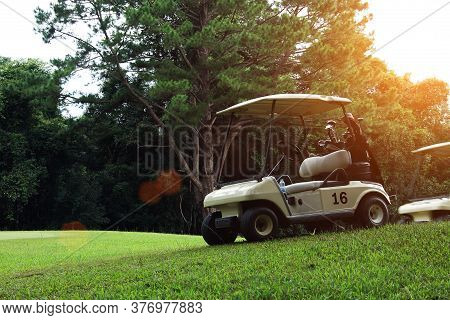 Golfcar In Beautiful Golf Course In The Evening Golf Course With Sunshine In Thailand