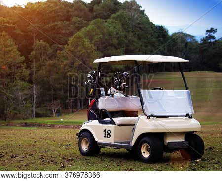 Golfcar In Beautiful Golf Course In The Evening Golf Course With Sunshine In Thailand