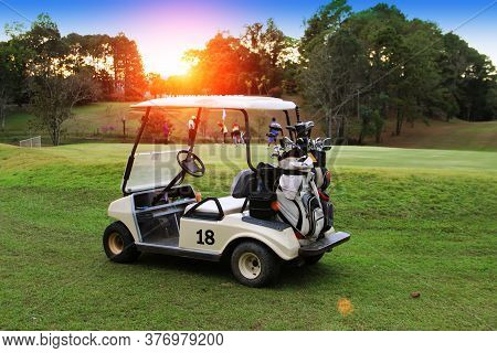 Golfcar In Beautiful Golf Course In The Evening Golf Course With Sunshine In Thailand