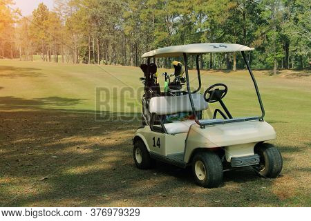 Golfcar In Beautiful Golf Course In The Evening Golf Course With Sunshine In Thailand
