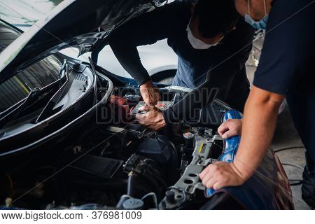 Checking A Car Engine For Repair At Car Garage