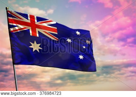 Fluttering Australia Flag On Colorful Cloudy Sky Background. Australia Prospering Concept.