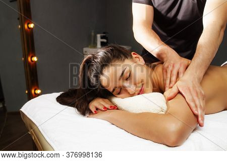 Back Massage. Classical, Therapeutic Massage. Girl On A Back Massage Procedure.