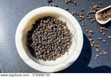 Peppercorns Of Piper Cubeba With A Wooden Spoon