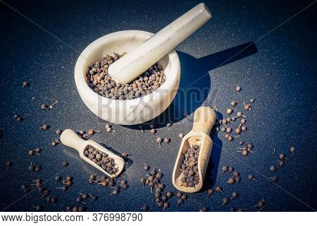 Peppercorns Of Piper Cubeba With A Wooden Spoon