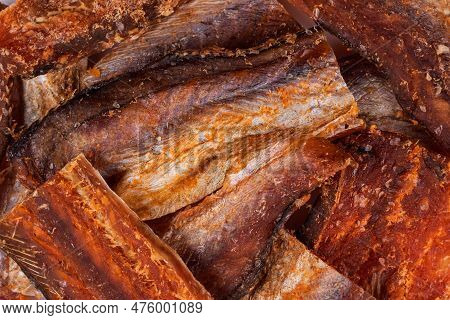 Pieces Of Cleaned Dried Fishbackground. Dry Peppered Pollack. Amber With Pepper Collection.