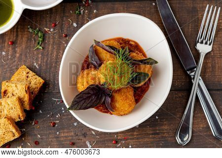 Homemade Fried Sicilian Arancini Stuffed With Meat, With Tomato Sauce