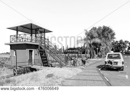 Keimoes, South Africa - Feb 25, 2023: A Viewpoint, Irrigation Canal, Waterwheel And A Vehicle, In Ke