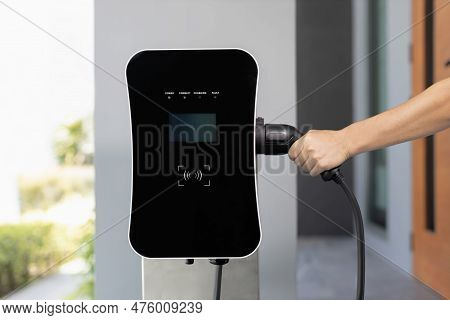 Closeup Hand Insert Ev Charger Plug, Green Energy-powered Charging Point Concept For Ev Car Connecte