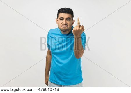 Sign Of Protest. Portrait Of Vulgar Unshaven Man Wearing Blue T- Shirt Shows Middle Finger Impolite 
