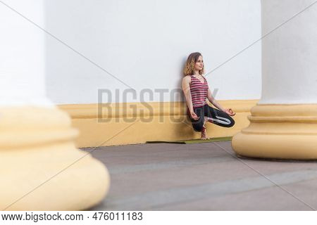 Athletic Young Adult Sporty Concentrated Fit Yogi Woman Instructor Doing Practice Hatha Yoga Outdoor