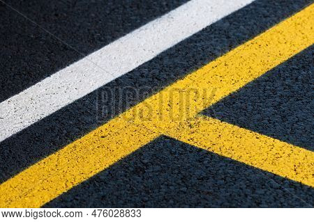 Road Marking On Brand New Asphalt Surface Of A Parking Lot, Yellow And White Lines As Abstract Backg