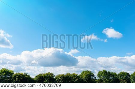Blue Sky With Fluffy Coluds Over Green Forest In Sunny Day Spring,fresh Air And Beautiful Natural La