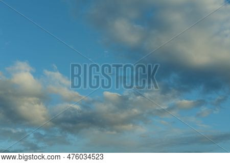 Blue Sky Background With White Fluffy Cumulus Clouds. Panorama Of White Fluffy Clouds In The Blue Sk