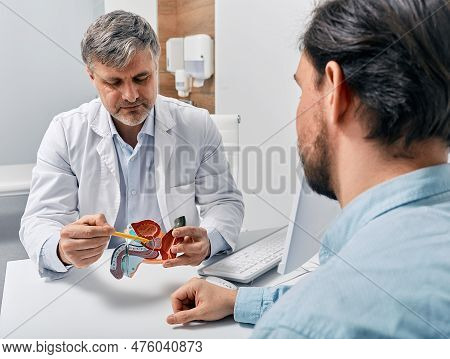 Doctor Urologist Consulting Patient With Prostatitis, Explaining To Him Methods Of Treatment Using A