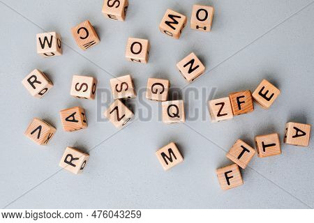 Wooden Cubes With Black Letters On A Gray Table, Close Up. Cubes Made Of Eco-friendly Material. Top 