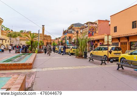 Marrakesh, Morocco - April 05, 2023: Medina Street Scene With Taxi Cars, Locals, And Visitors, In Ma